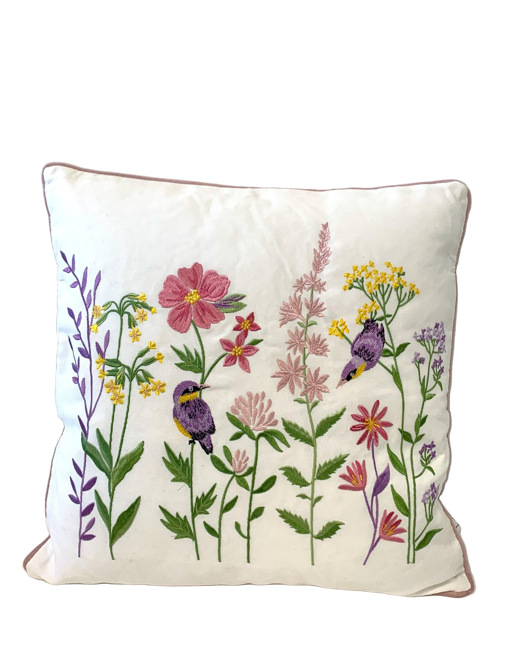Decorative pillow with floral and bird embroidery on a white background