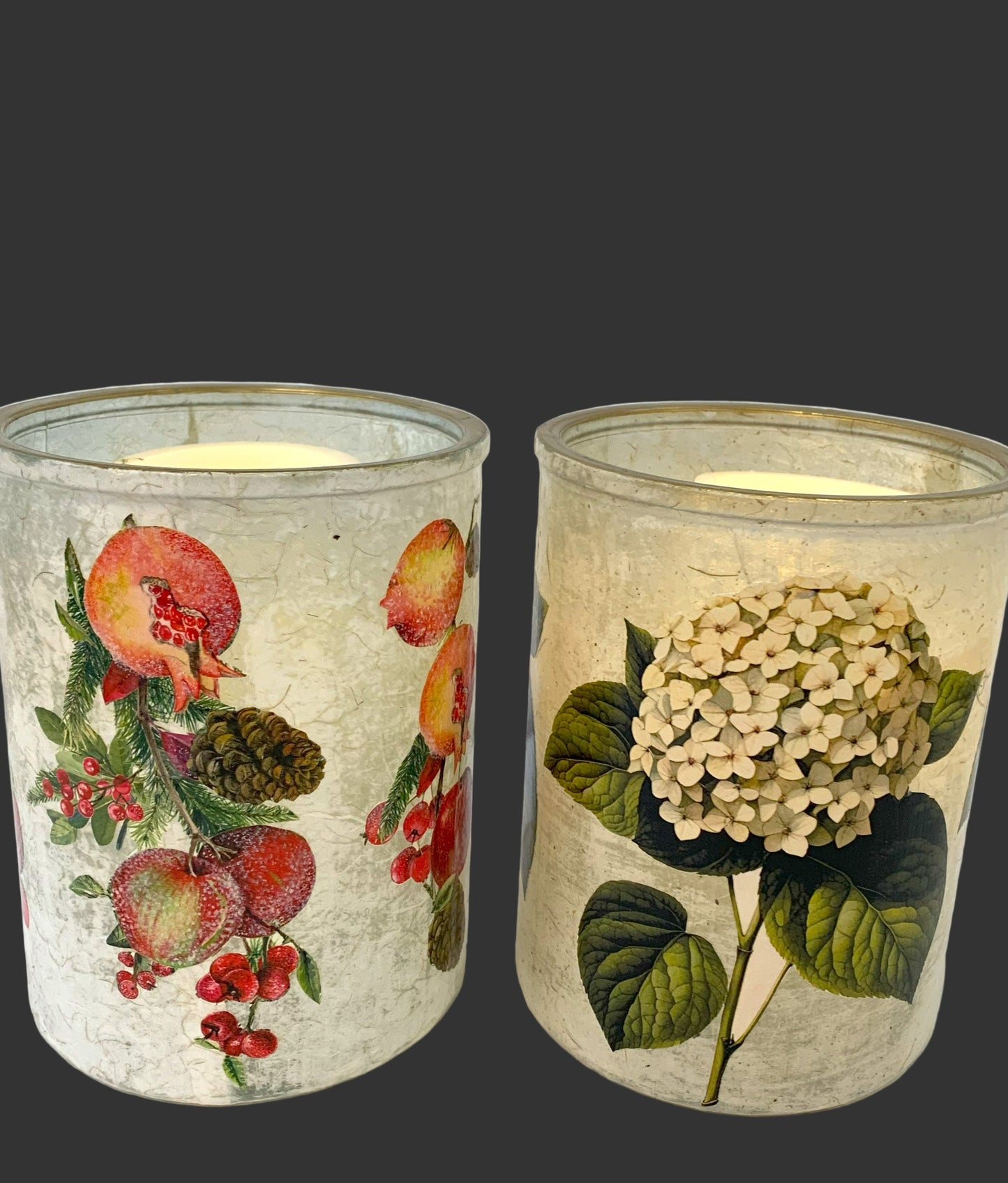 Two candle holders with floral designs on a white background