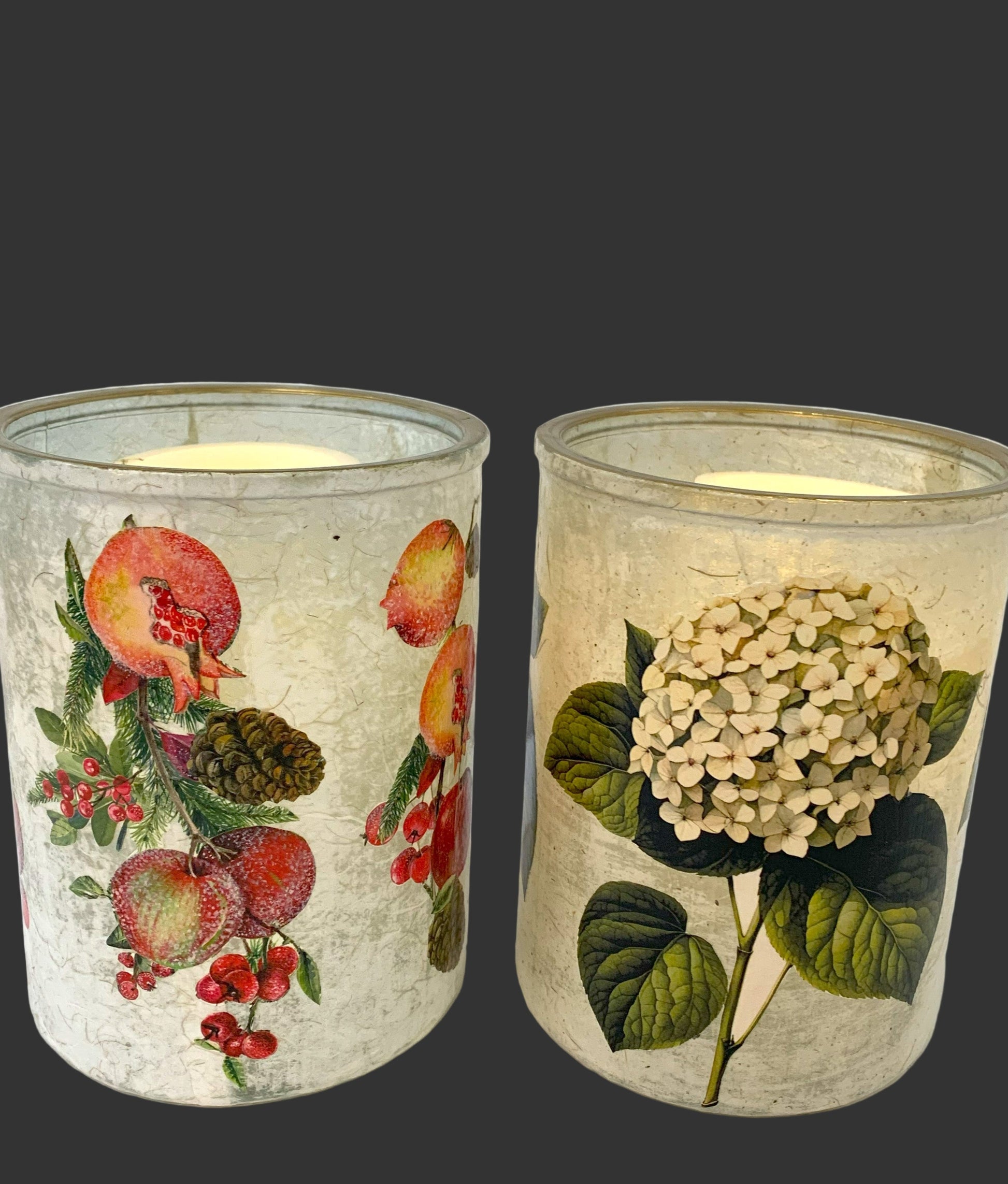 Two candle holders with floral designs on a white background