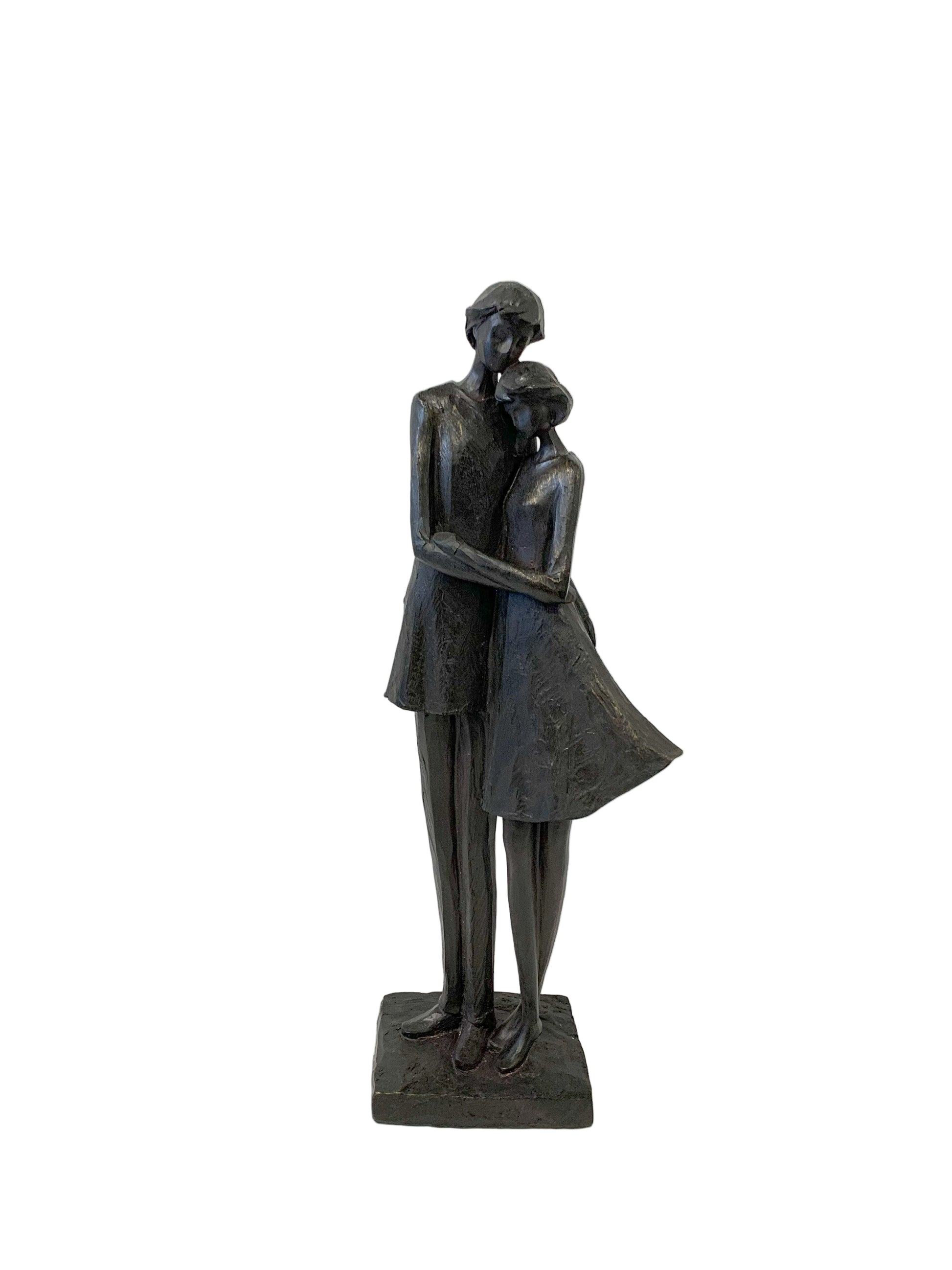 Bronze statue of a couple embracing on a white background