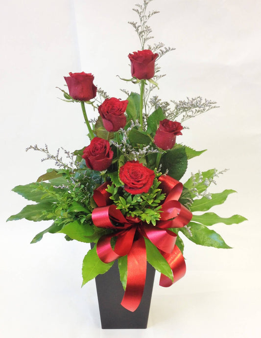 6 red roses in waterbox