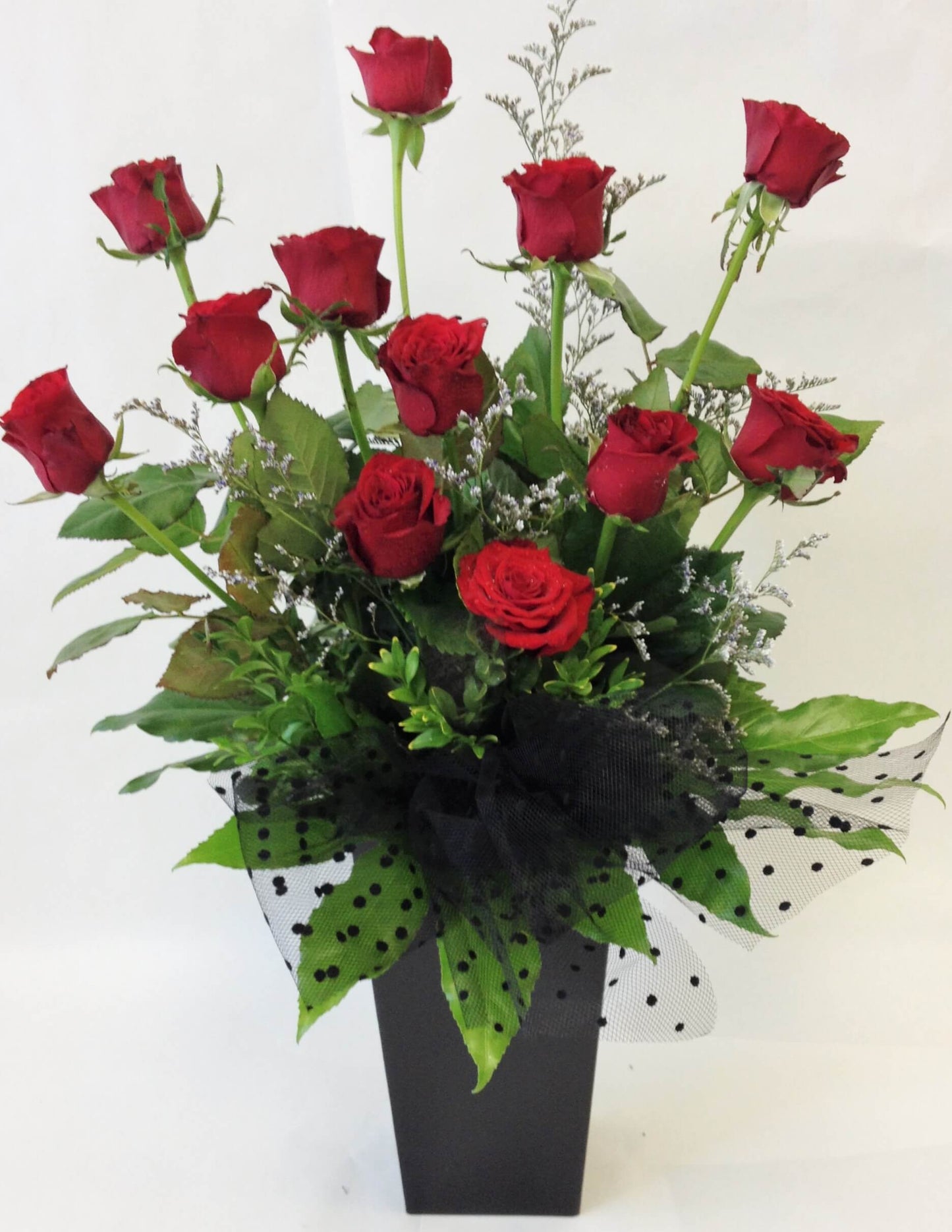 12 red roses in a water box