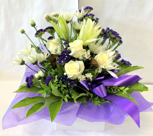 Box Arrangement in purple and white with roses, chrissy's, carnations and lillies