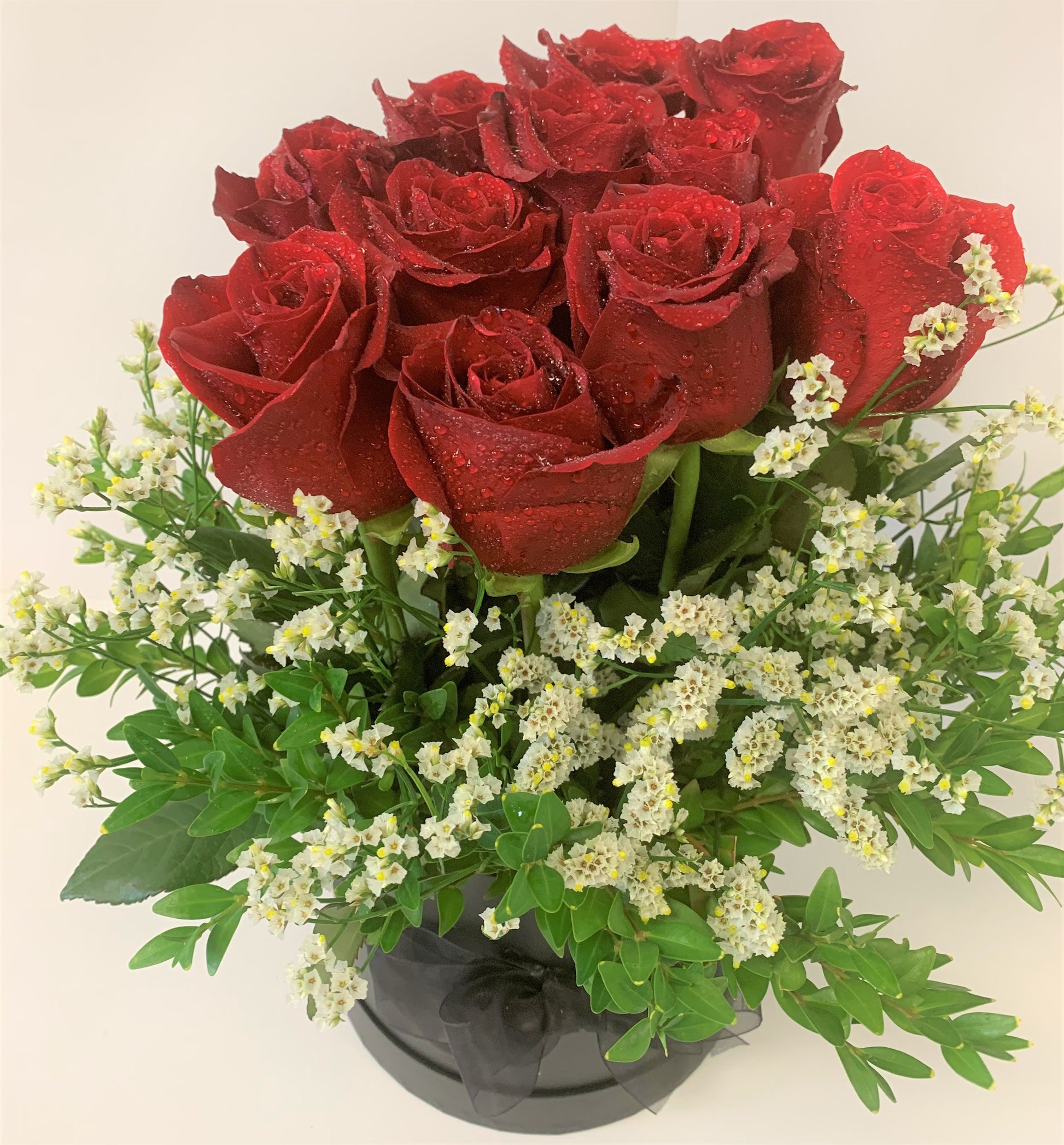 12 Beautiful red roses in water in a decorative box for your special friend or lover for Valentines day. 